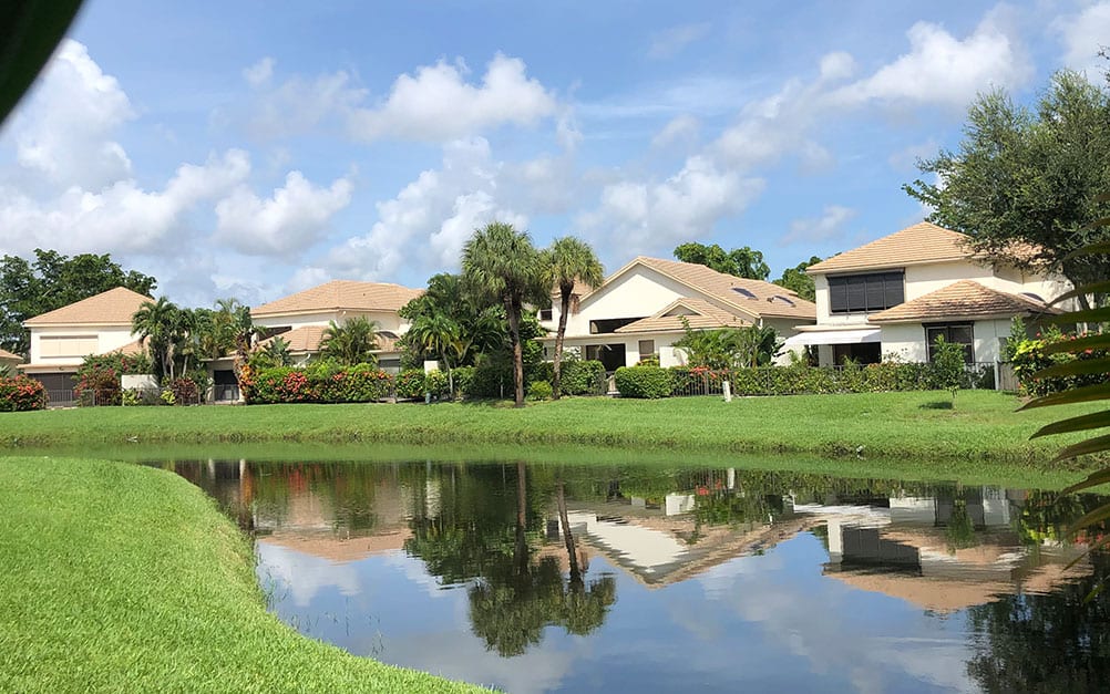 Group of Boca West Homes with lake behind them